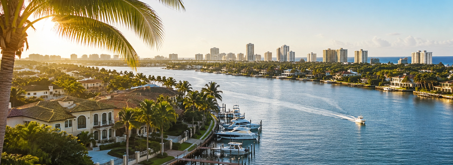Southeast Florida waterway surrounded by homes, palms, and a coastal skyline